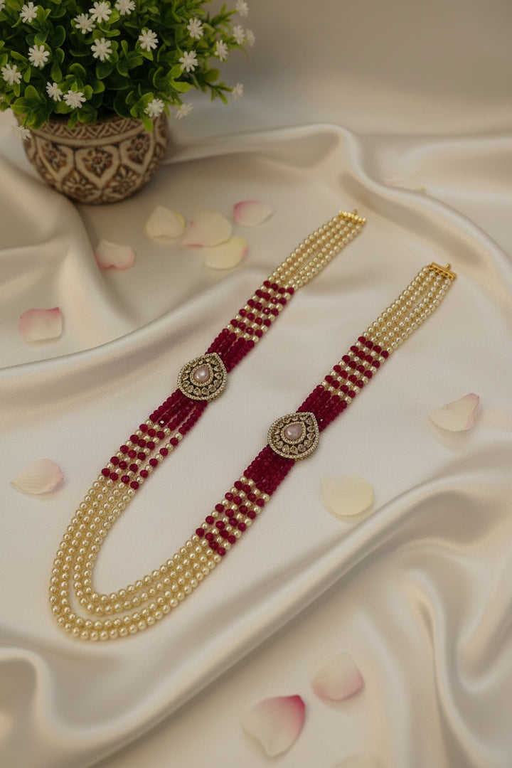 Beaded belt with gold and red threading on a light background